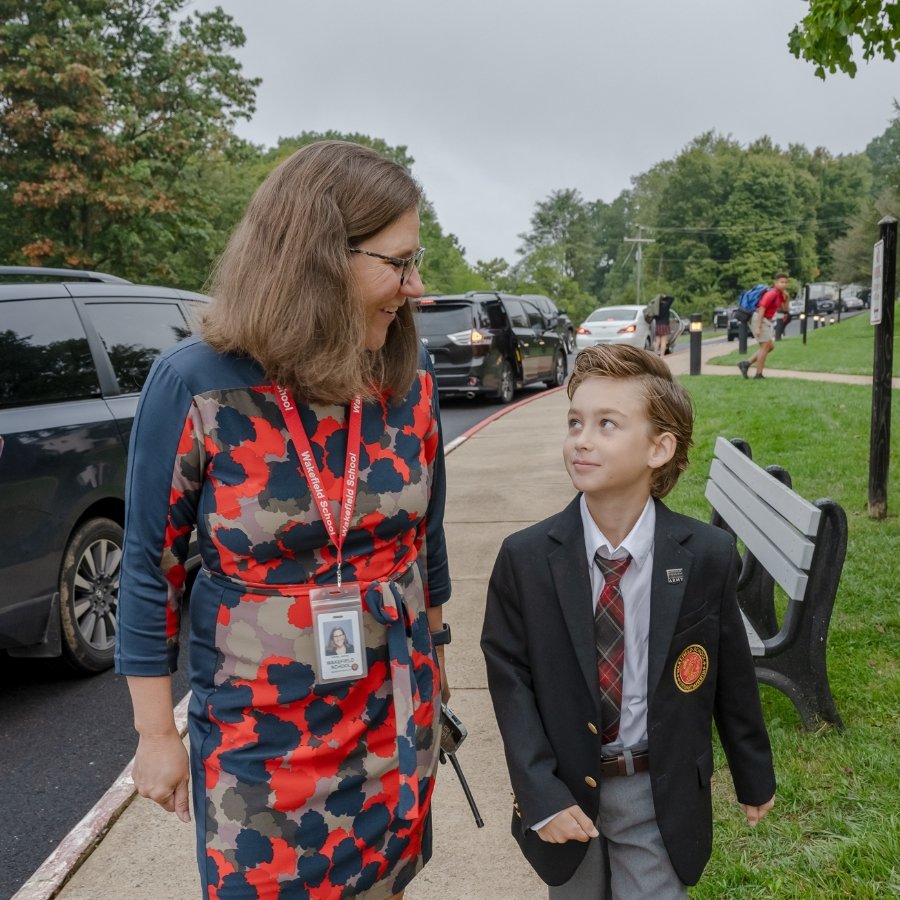 Ashley Harper, Head of School walking with a student