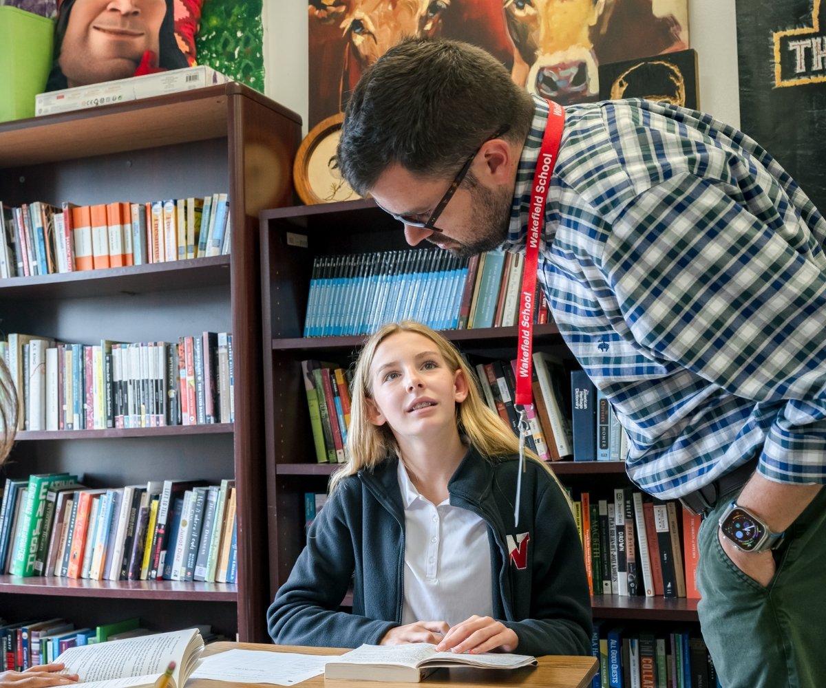 student and teacher working on an assignment