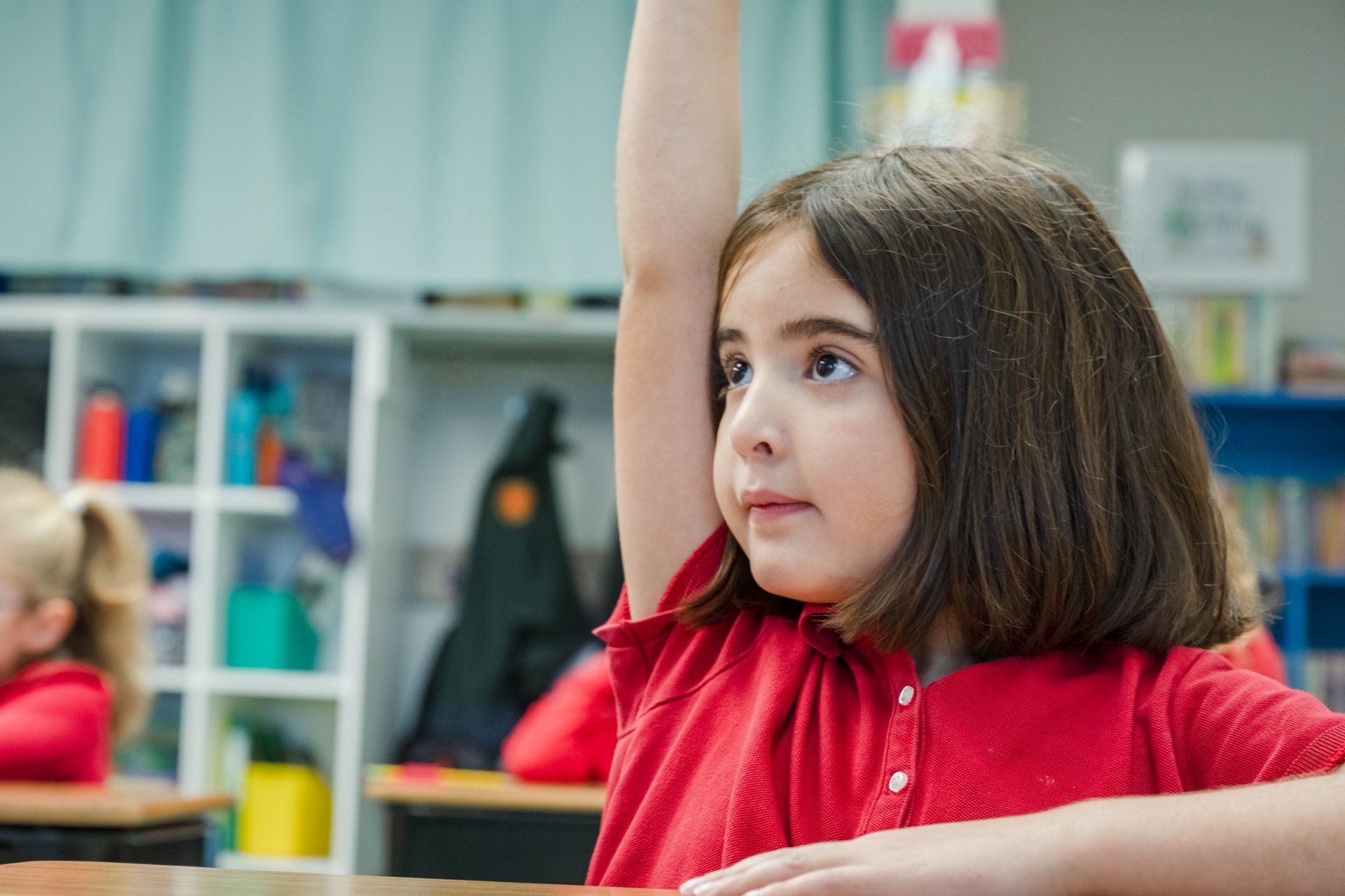 Wakefield Lower School student, politely raising her hand in class