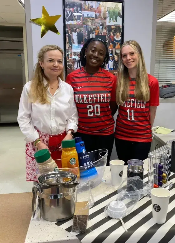 parent volunteer and two students helping with Teacher Appreciation Week